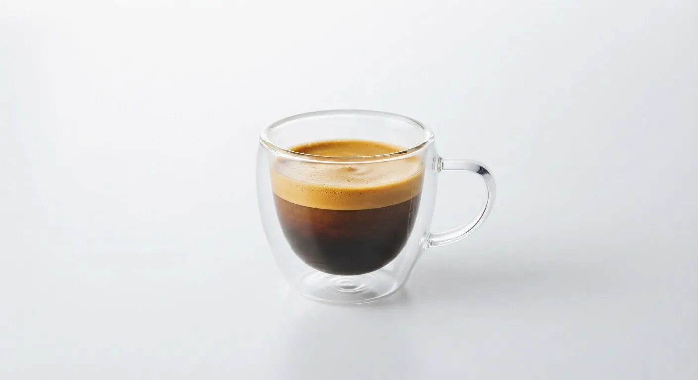 A double-walled glass cup of coffee.